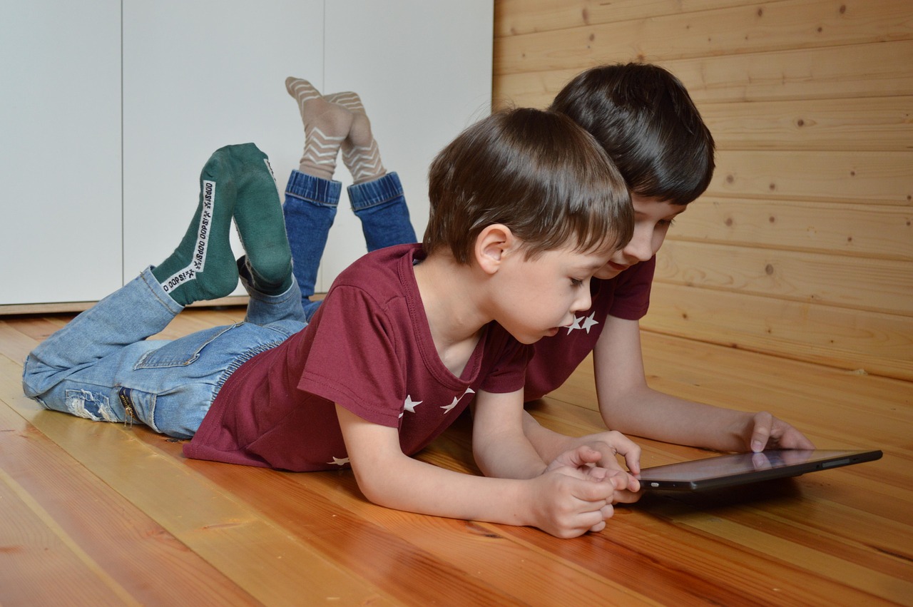 Infant utilitzant una tauleta amb supervisió adulta, simbolitzant un ús saludable de pantalles